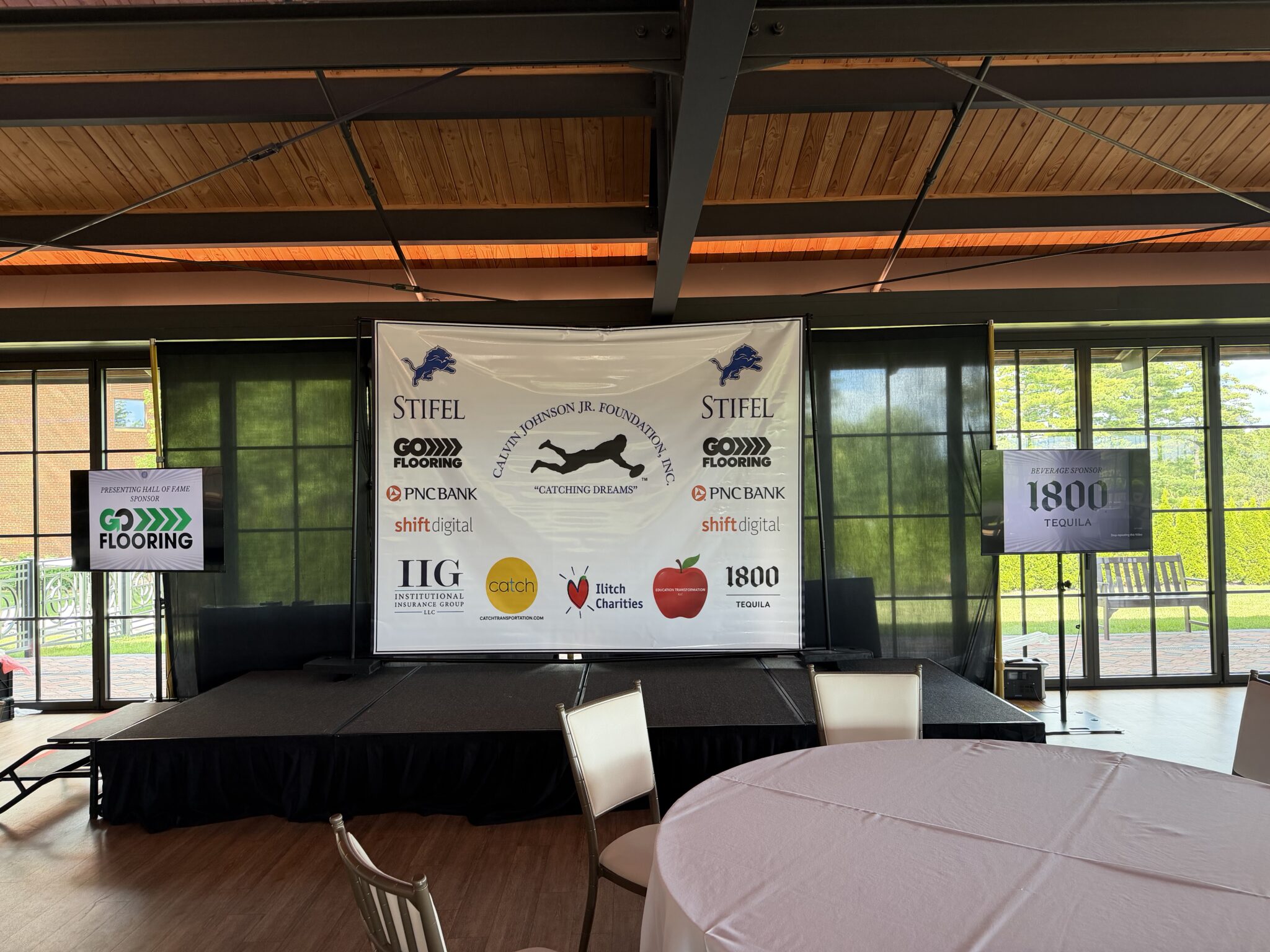 Go Flooring logo on the sponsor banner at the Calvin Johnson Jr Foundation Celebrity Golf Classic