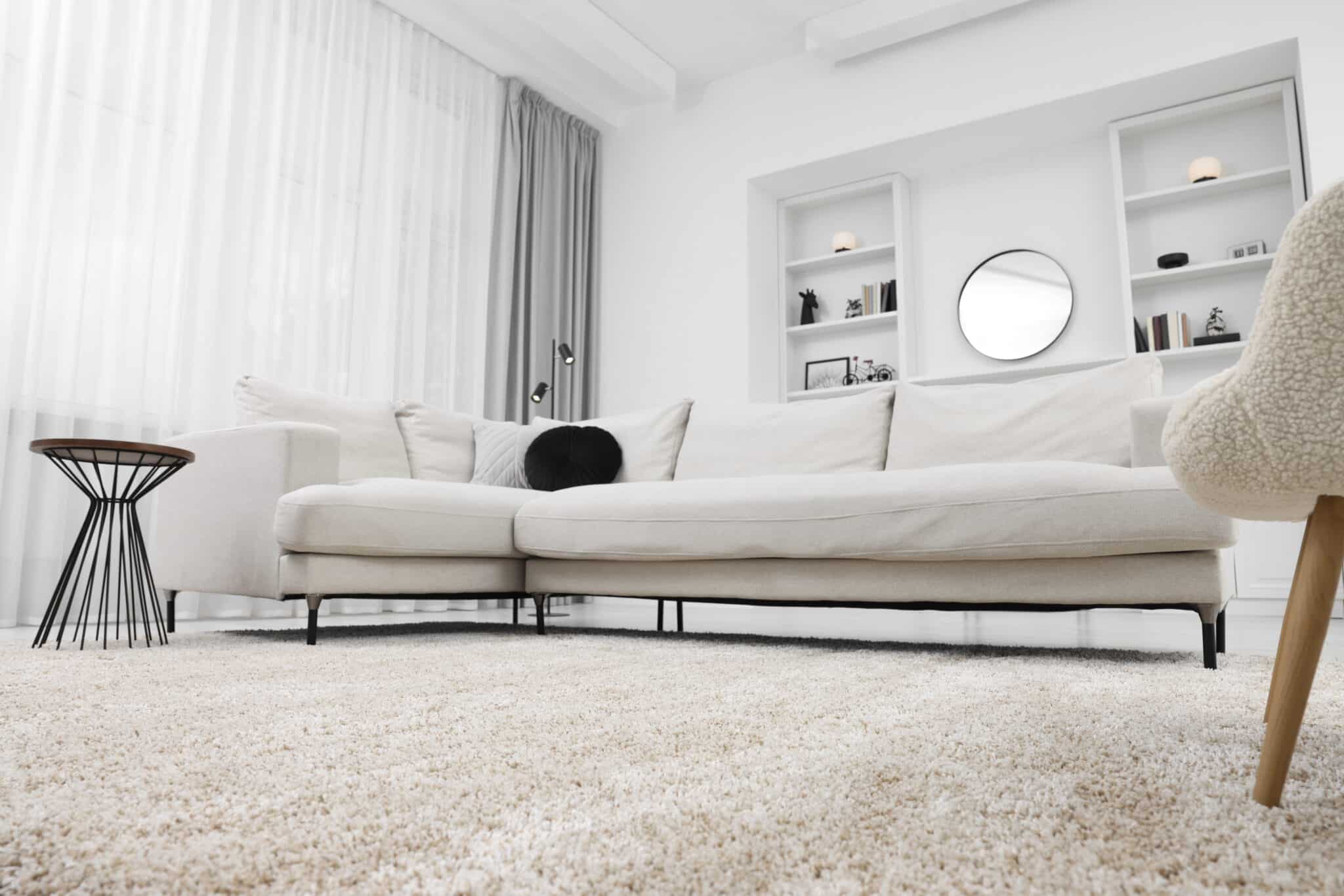 Soft cream carpet filling the foreground of a bright modern living room