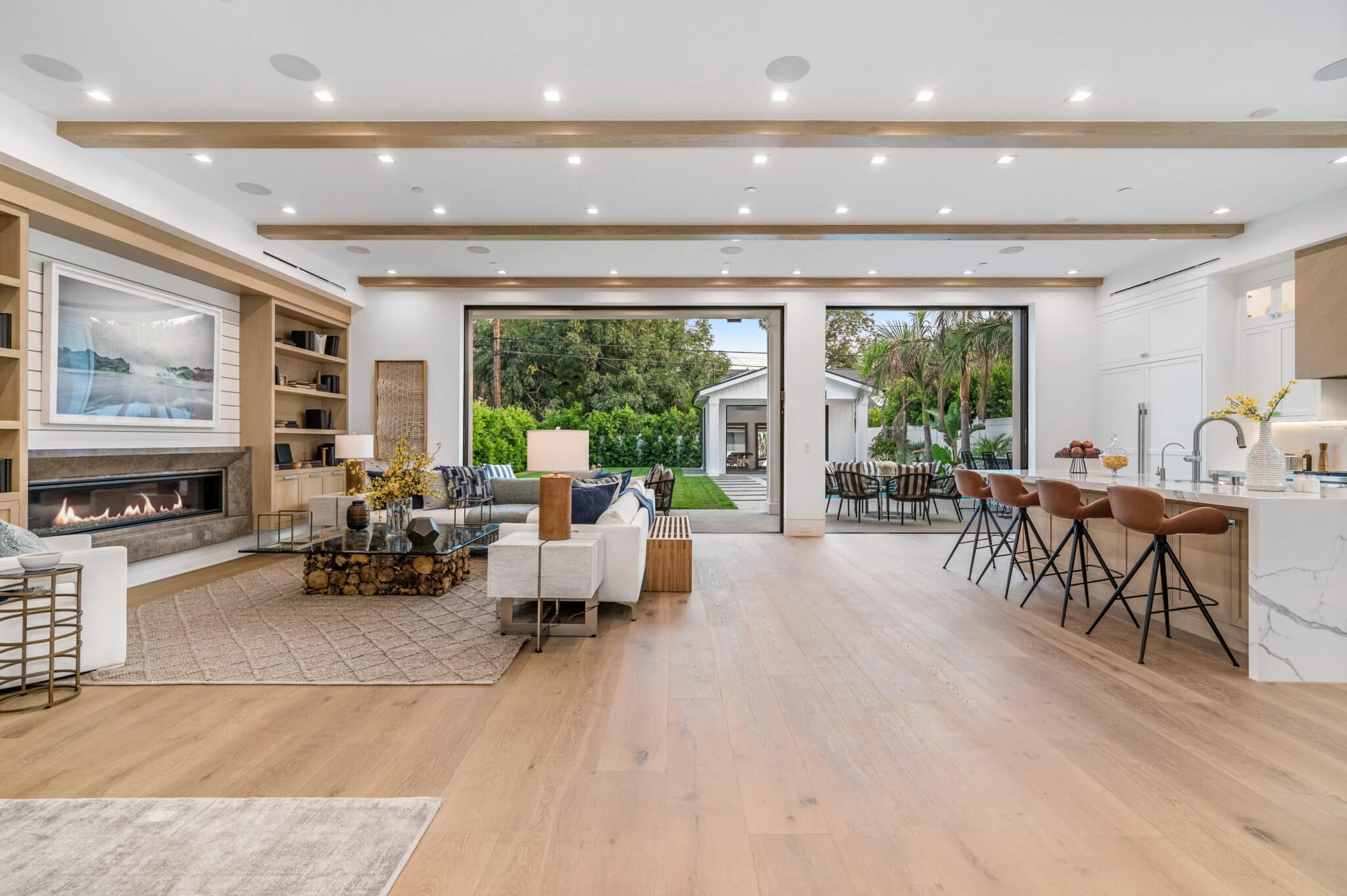Open-concept home with wood flooring flowing from the living room into the kitchen