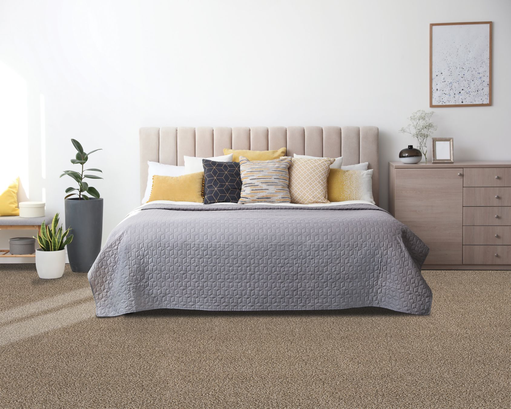 Warm taupe carpet covering a bedroom floor with an upholstered bed